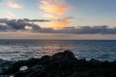 Sunrise over atlantic ocean from fuencaliente, la palma with volcanic igneous rocks in foreground
