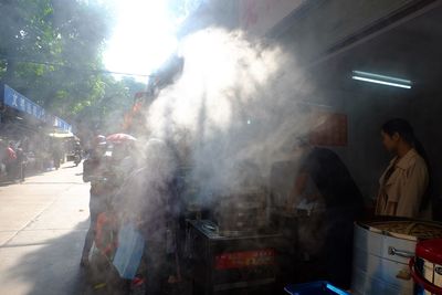 People at market stall in city