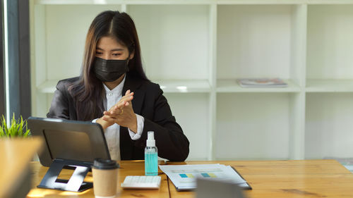 Full length of woman working on table