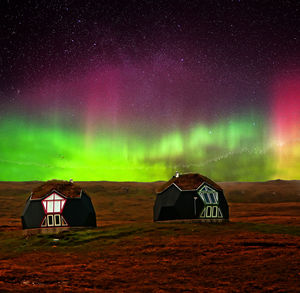 View of car on landscape against sky at night