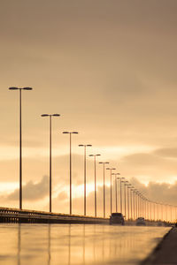 Silhouette bridge against sky during sunset