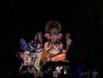 Low angle view of carousel statue at night