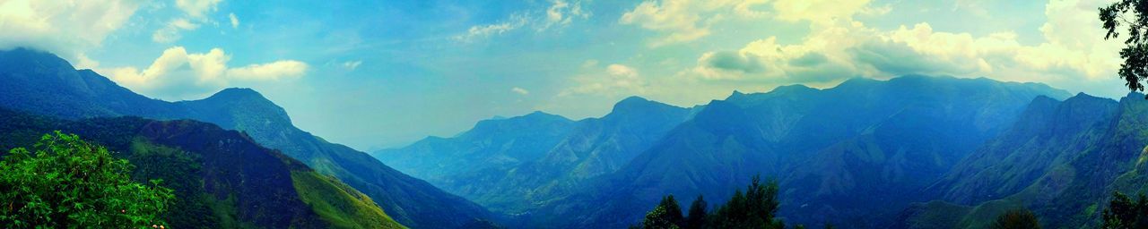 Scenic view of mountains against cloudy sky