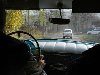 Rear view of man driving car