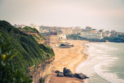 High angle view of beach and buildings against sky