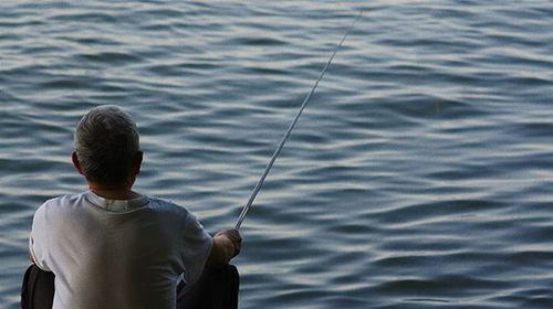 Cropped image of woman fishing in water