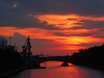 Scenic view of river against orange sky