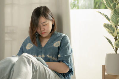 Portrait of a smiling girl sitting at home