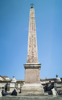 Low angle view of historical building against blue sky