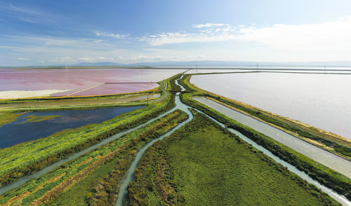 Multi colored water in ponds and stream in salt marsh in sf bay aerial