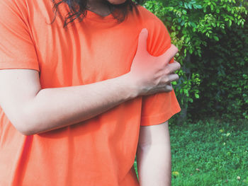 Midsection of woman standing on field