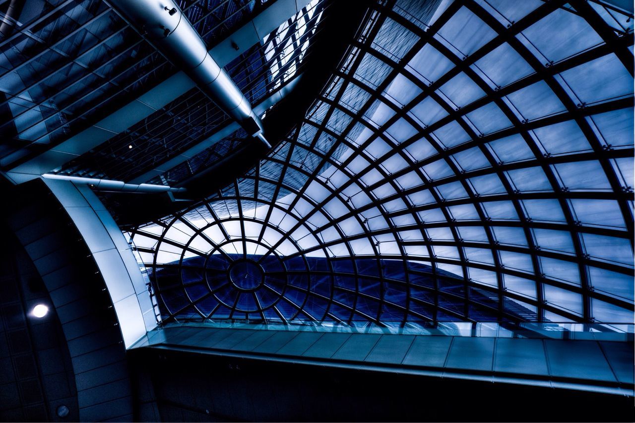 architecture, built structure, glass - material, low angle view, indoors, modern, building exterior, window, skylight, transparent, building, architectural feature, pattern, reflection, ceiling, office building, glass, sky, city, geometric shape