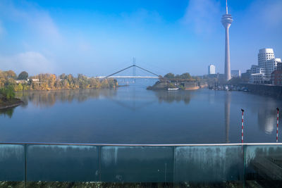 Bridge over river with city in background