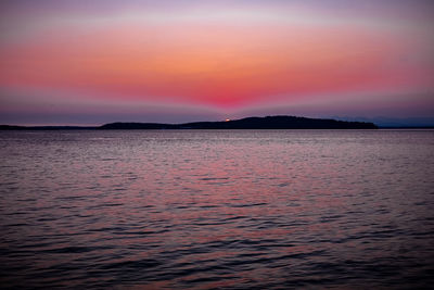 Scenic view of sea against romantic sky at sunset