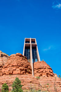 Low angle view of mountain against clear blue sky