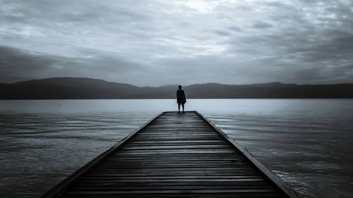 Pier on lake against sky