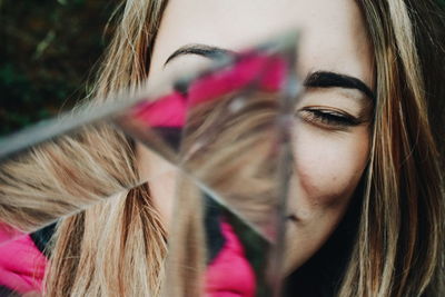 Close-up of young woman holding glass