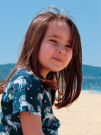 Portrait of young woman sitting at beach