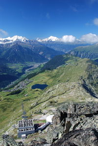 Scenic view of rocky mountains against blue sky on sunny day