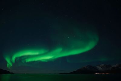 Scenic view of lake against sky at night