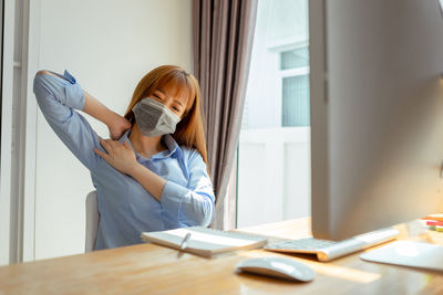 Portrait of woman working on table