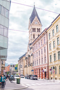 View of city street and buildings against sky