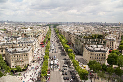 High angle view of city street against cloudy sky