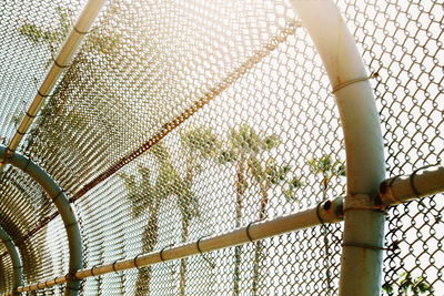 Close-up of chainlink fence against sky