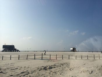 Scenic view of beach against clear sky during winter