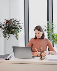 Young woman using laptop at home