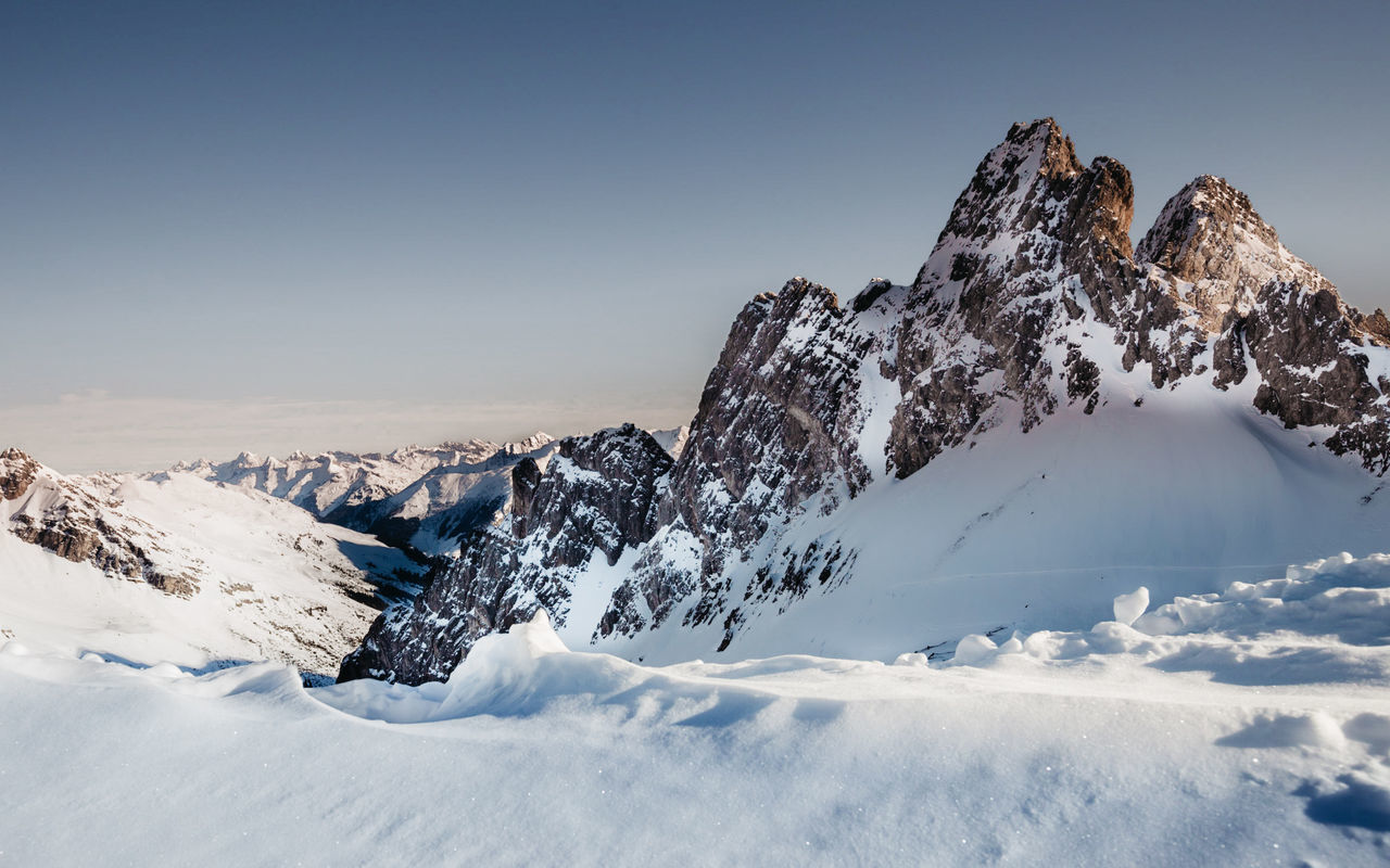 snow, winter, cold temperature, mountain, scenics - nature, landscape, environment, mountain range, sky, beauty in nature, nature, snowcapped mountain, travel destinations, ski touring, ski mountaineering, no people, travel, mountain peak, outdoors, clear sky, blue, tranquility, sports, tranquil scene, winter sports, frozen, panoramic, land, ridge, day, sunny, white, piste