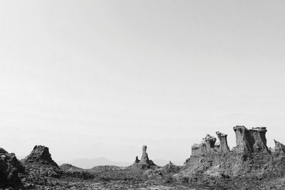 Panoramic view of rocks on field against clear sky