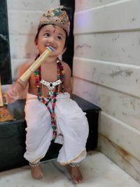 Portrait of cute girl holding camera at home