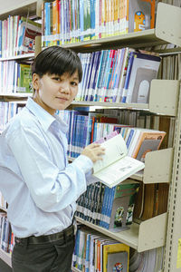 Rear view of man standing in library