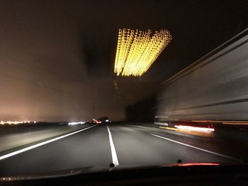 Close-up of illuminated road at night