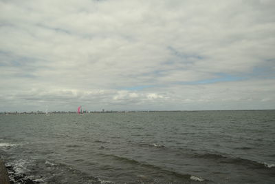 Scenic view of sea against cloudy sky