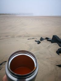 High angle view of drink on sand at beach