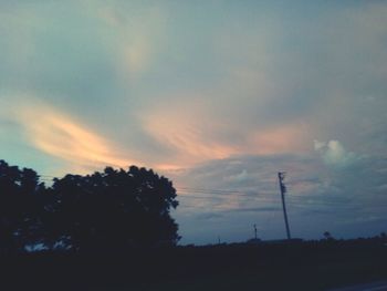 Silhouette trees against sky during sunset