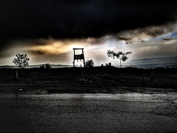 Scenic view of silhouette field against sky during sunset