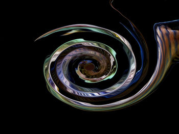 Close-up of spiral glass against black background