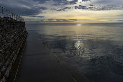 Scenic view of sea against sky at sunset
