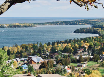 High angle view of houses by sea against sky