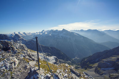 Scenic view of snowcapped mountains against blue sky