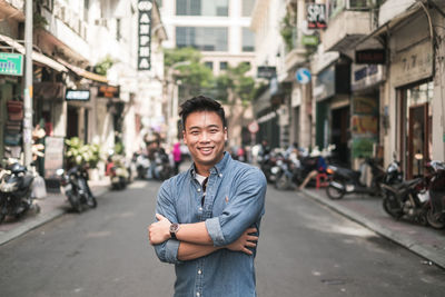 Portrait of young man standing on street