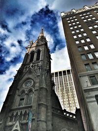 Low angle view of church against cloudy sky