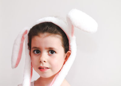 Beautiful caucasian girl with a smile  looks at the camera with a fashionable easter bunny headband 