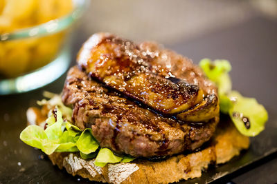 Close-up of meat with bread on table