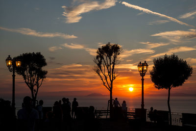 Silhouette people against sky during sunset