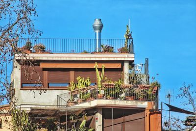 Low angle view of built structures against clear blue sky
