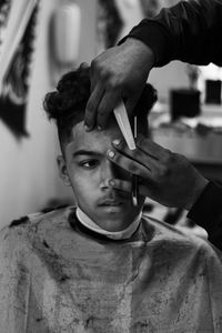 Close-up of man cutting hair